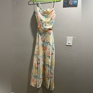 It has been never worn. Tie from the back and is like a silk material